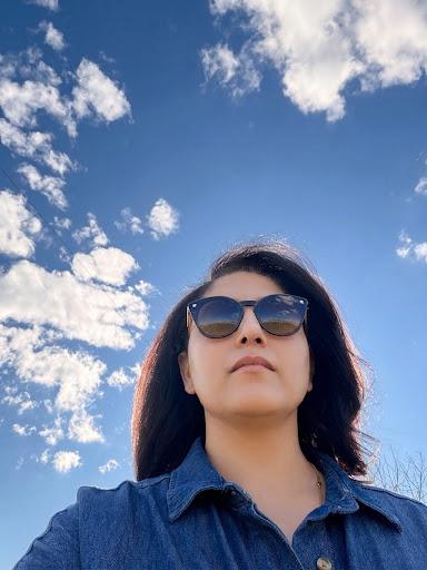 Saloni outdoors beneath a blue sky
